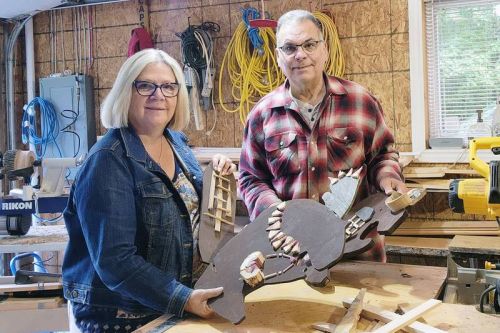 Phil and Julie Tompkins of Devil Lake Rd working on a “Beaver Tea Party” sculpture. They are two of a larger group collaborating on this particular piece